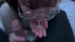 A girl with neat glasses gets ejaculated in the mouth.